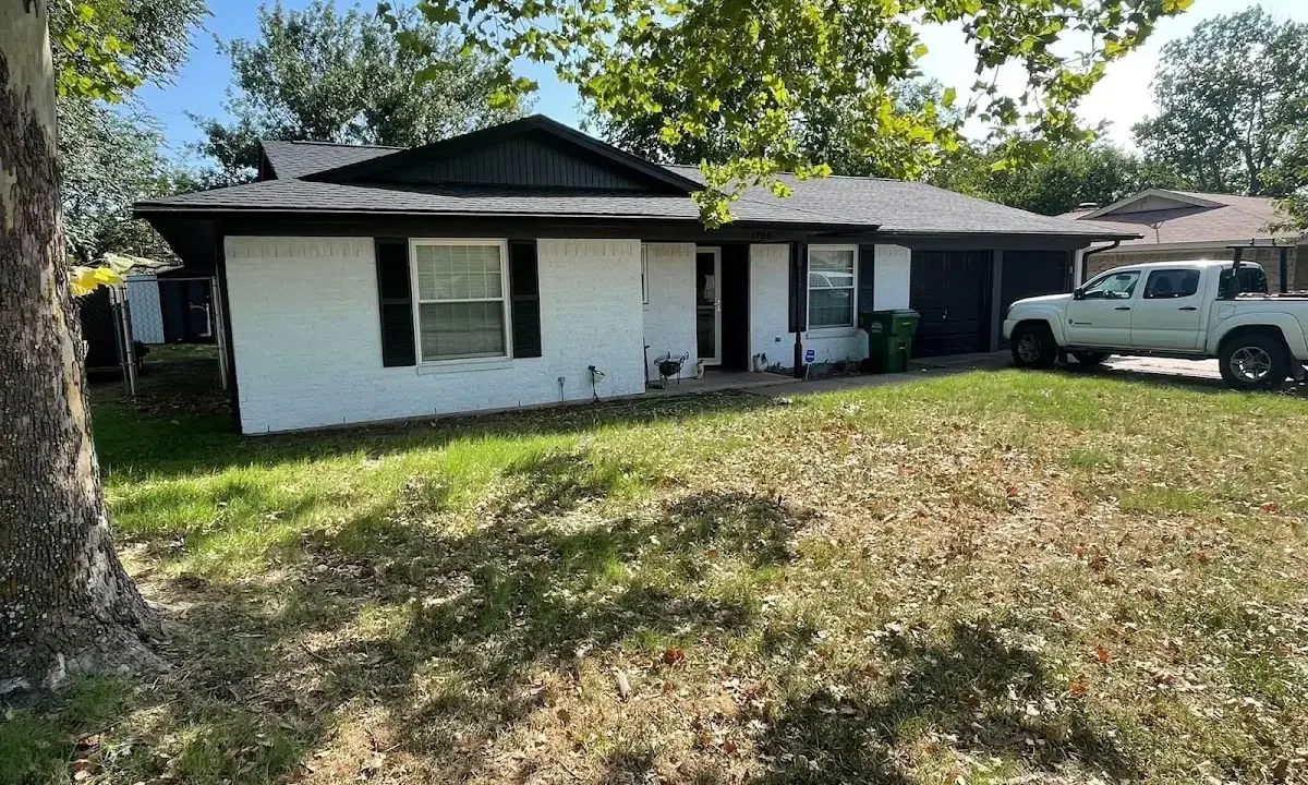 Professional roofing crew working on a residential roof in East Moline
